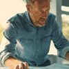 a professional roofing contractor meticulously discusses the installation process with a homeowner in a modern office setting, surrounded by detailed blueprints and samples, showcasing the importance of workmanship warranties for ensuring quality roofing.
