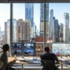 a dynamic urban office setting showcases a team of licensed roof repair specialists engaged in an animated discussion over project blueprints, emphasizing their expertise and commitment to local building codes amid a backdrop of city skyscrapers.